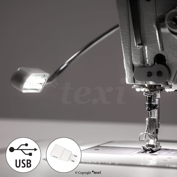 Lampka do maszyn szwalniczych TEXI LED z 12 diodami LED, z elastycznym ramieniem. Umożliwia zasilanie przez USB. Widoczna na zdjęciu w pobliżu igły maszyny, na białym tle. Akcesoria USB w dolnym rogu.