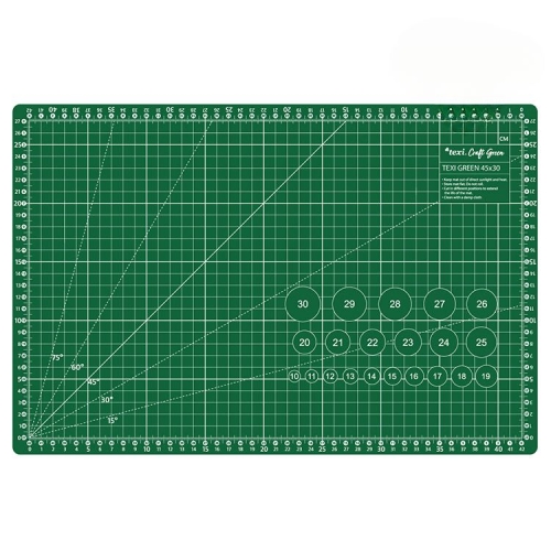 Zielona mata podkładowa TEXI GREEN 45x30 cm, samoregenerująca, z siatką milimetrową i kątami. Widoczne okręgi z numerami oraz linie pomocnicze do precyzyjnego cięcia. Ułożona na płasko, na jednolitym tle.