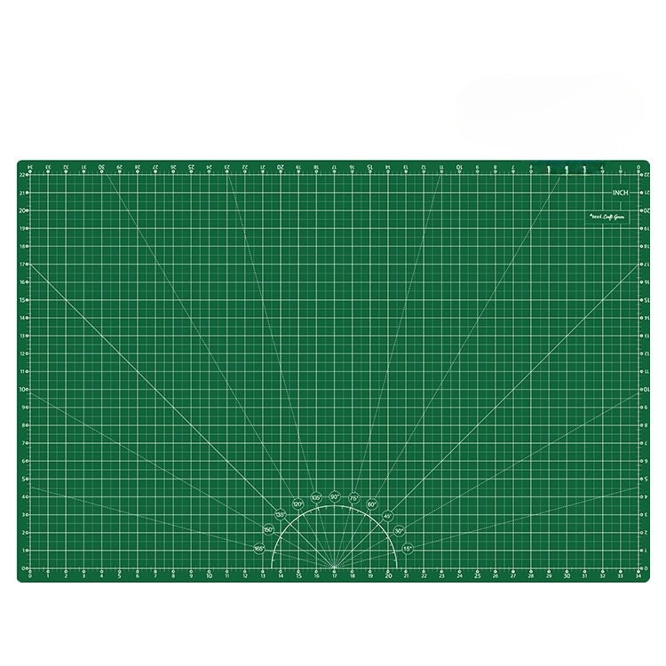 Zielona mata podkładowa TEXI GREEN o wymiarach 90x60 cm, samoregenerująca, z siatką podziału w centymetrach i calach. Ujęcie frontalne, na prostym tle, ukazuje gładką, teksturowaną powierzchnię z naniesionymi liniami pomocniczymi.