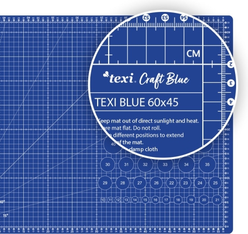 Samoregenerująca mata podkładowa TEXI BLUE w kolorze niebieskim o wymiarach 60x45 cm, z siatką pomiarową i wyraźnymi oznaczeniami w centymetrach. Ułożona na płasko, z instrukcją użytkowania w górnej części.