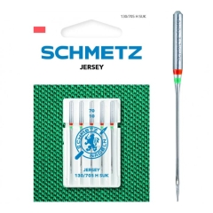 Igły półpłaskie Schmetz 130/705H SUK do jerseyu, zestaw 5 sztuk w opakowaniu. Igły o numerze 70, umieszczone w przezroczystym etui, z logo Schmetz. Tło w kolorze zielonym, materiał teksturowany.