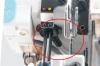 Zbliżenie na mechanizm owerloka Jack C5F-5, ukazujące czarny wąż oraz elementy mocujące. Widoczne są także przyciski w kolorach żółtym i czerwonym. Tło jest jasne, co podkreśla szczegóły produktu.