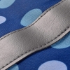 Niebieska torba w kropki na maszynę do szycia, wykonana z materiału, z szarym, skórzanym detalem na krawędzi. Widoczny fragment zbliżenia na teksturę materiału i wykończenie.