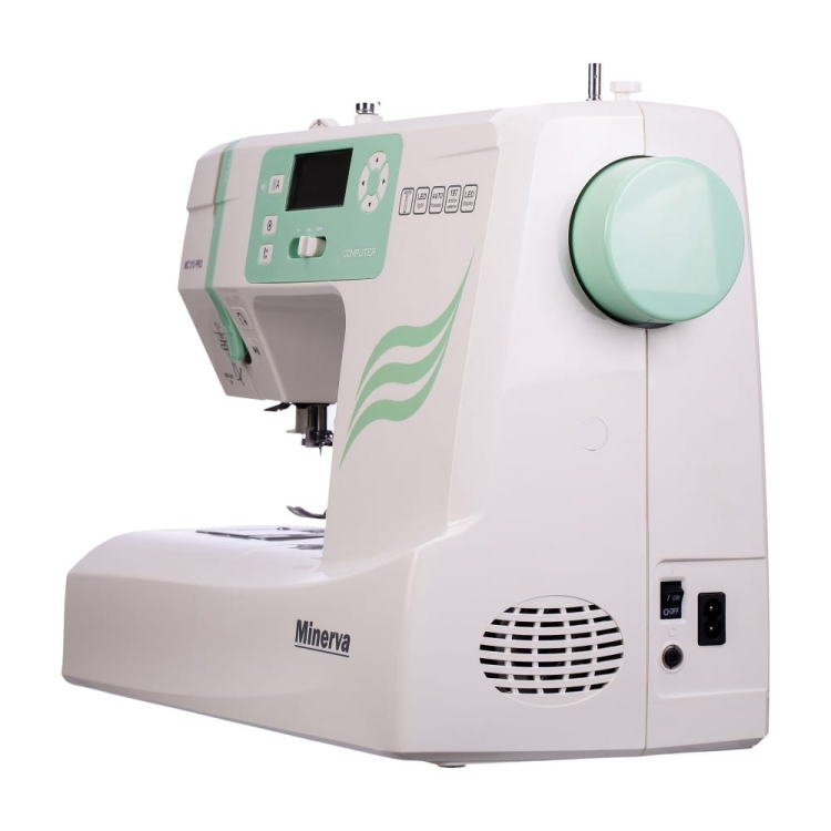 Maszyna do szycia Minerva MC210 Pro w kolorze białym z zielonymi akcentami. Widok z boku, z wyświetlaczem LCD i przyciskami. Widać pokrętło do regulacji. Na obudowie logo Minerva. Produkt z zamontowanym uchwytem na nici.