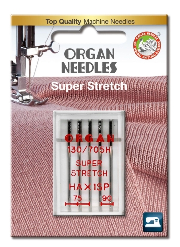Igły półpłaskie Organ HAx1SP do stretchu w mixie rozmiarów 75-90, umieszczone w przezroczystym blistrze. Widoczny napis Super Stretch oraz oznaczenia rozmiarów. Tło w odcieniu różowym z fakturą materiału.