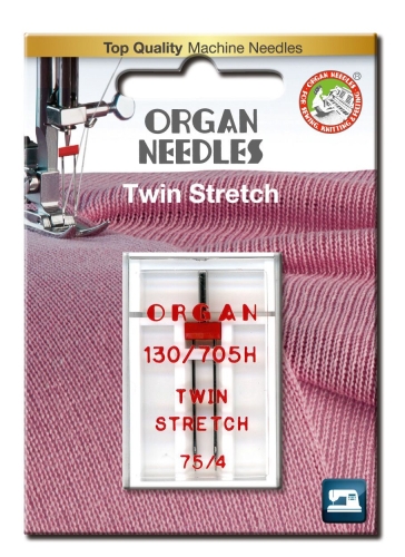 Igła podwójna półpłaska 130/705H Organ TWIN do stretchu 75/4mm w przezroczystym blistrze. Na tle różowej tkaniny widoczne napisy: ORGAN, 130/705H, TWIN STRETCH, 75/4. Produkt ułożony na równym tle.