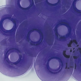 Fioletowe szpulki do maszyn Pfaff z grupy L, w zestawie 10 sztuk. Szpulki mają okrągły kształt z centralnym otworem. Przezroczysty materiał pozwala na łatwe sprawdzenie zawartości. W tle widoczny symbol recyklingu.