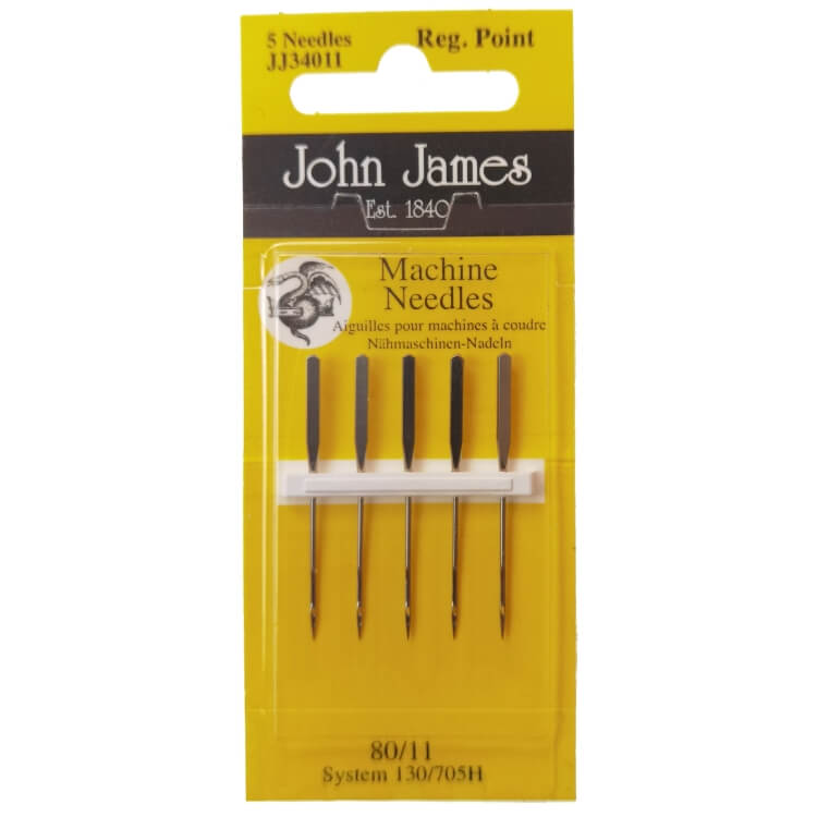 Igły półpłaskie 130/705H uniwersalne 80, opakowanie 5 sztuk. Widoczne czarne uchwyty igieł na białym plastikowym stelażu, z nadrukiem Machine Needles oraz logo John James. Tło żółte z informacjami o systemie i rozmiarze.