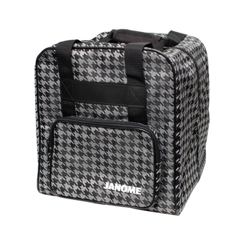 Torba Janome w czarno-szarym wzorze houndstooth, w formie prostokątnej, z dwiema rączkami i kieszenią z przodu z zamkiem. Widoczne logo JANOME w dolnej części. Produkt stoi na płaskiej powierzchni.