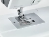 Maszyna do szycia BERNETTE B37 w zbliżeniu, ukazująca stopkę, igłę oraz panel z oznaczeniami ściegów na metalowej podstawie. Widoczne są elementy mechanizmu szycia oraz logo bernette. Tło białe, co podkreśla detale produktu.